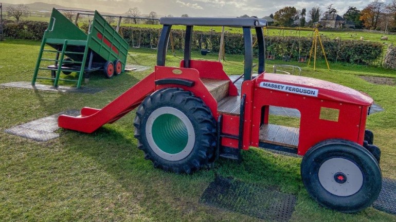 Massey Ferguson playground tractor slide celebrates village farming community and memory of Lakeland machinery